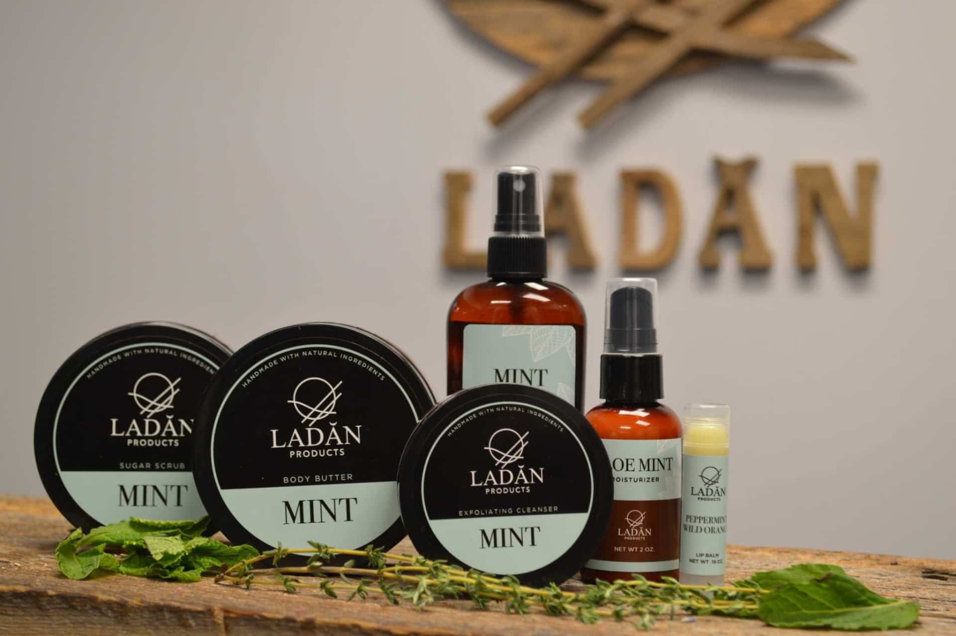 Full color photo of Ladan Products on a wooden shelf with fresh greenery.